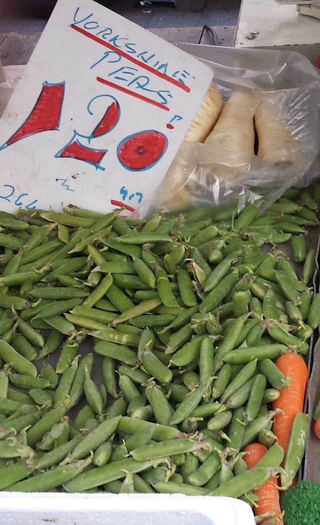 Fresh peas for sale in their pods on a UK market stall