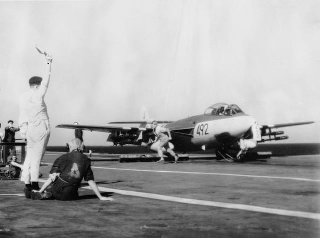 A Hawker Sea Hawk of 899 Naval Air Squadron, armed with rockets, about to be launched from the aircraft carrier HMS Eagle for a strike on an Egyptian airfield