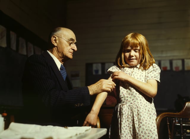Doctor administering a typhoid vaccination at a school in San Augustine County, Texas, 1943
