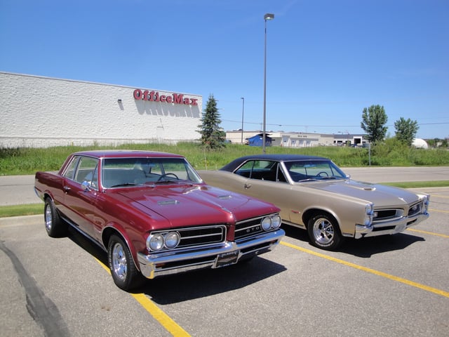 A 1964 GTO (left) with a 1966 GTO (right) showing the difference in design