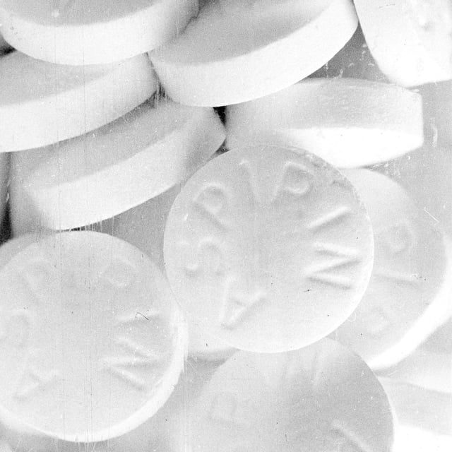 Uncoated aspirin tablets, consisting of about 90% acetylsalicylic acid, along with a minor amount of inert fillers and binders