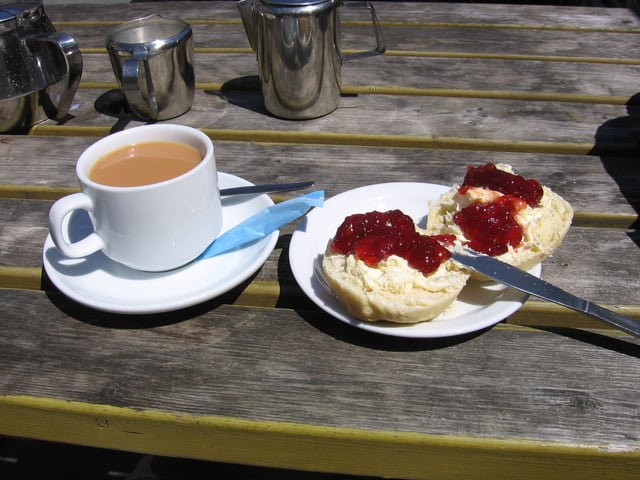 Devon cream tea, comprising tea taken with scones, clotted cream and jam