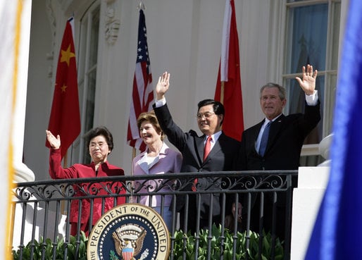 Presidents George W. Bush, and Hu Jintao with first ladies Laura Bush, and Liu Yongqing wave from the White House in April 2006.