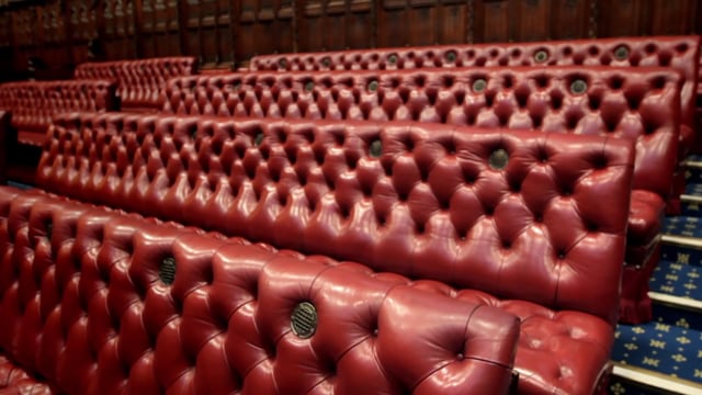 Benches in the chamber are coloured red. In contrast, the benches in the House of Commons are green.