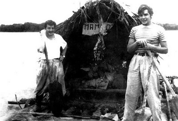 Guevara (right) with Alberto Granado (left) in June 1952 on the Amazon River aboard their "Mambo-Tango" wooden raft, which was a gift from the lepers whom they had treated