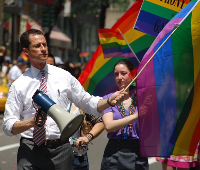 Weiner shows his support for the LGBT community during the New York City Gay Pride Parade, 2009. His wife (at that time) Huma Abedin can be seen standing next to him.