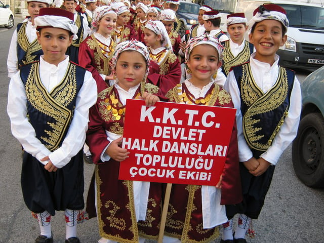 Turkish Cypriot children, dressed in traditional clothing, preparing for a folk-dance show