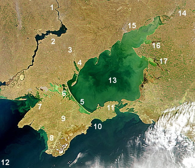 Satellite image of Sea of Azov. The shallow Sea of Azov is clearly distinguished from the deeper Black Sea. Numbers: 1. Dnieper River, 2. Kakhovka Reservoir, 3. Molochna River, 4. Molochny Liman, 5. Arabat Spit, 6. Sivash lagoon system, 7. Karkinit Bay, 8. Kalamitsky Bay, 9. Crimea, 10. Fedosiysky Bay, 11. Strait of Kerch, 12. Black Sea, 13. Sea of Azov, 14. Don River (Russia), 15. Taganrog Bay, 16. Yeysk Liman, 17. Beisug Liman