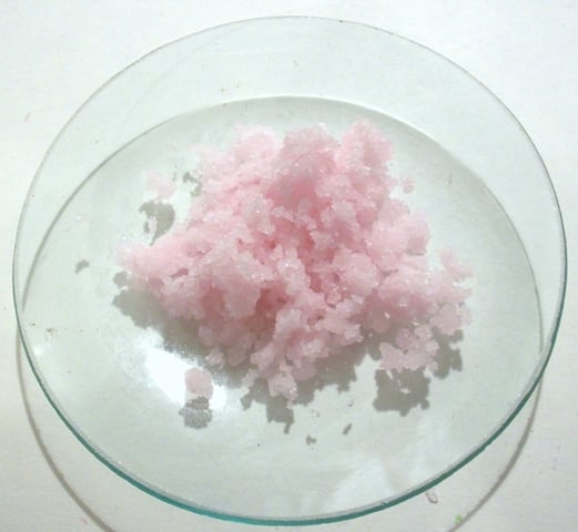 Manganese(II) chloride crystals – the pale pink color of Mn(II) salts is due to a spin-forbidden 3d transition.