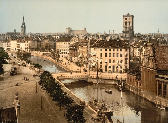 Slotsholmen canal, as seen from the Børsen building (c. 1900). In the background from left to right: Church of the Holy Ghost, Trinitatis Complex, St. Nicholas Church and Holmen Church