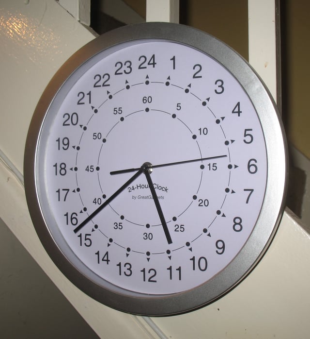 A modern quartz clock with a 24-hour face