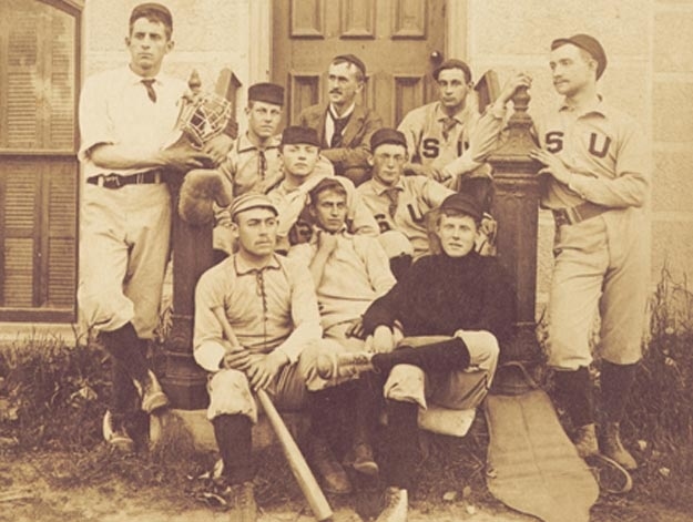 Stephen Crane (front row, left) sits with baseball teammates on the steps of the Hall of Languages, Syracuse University, 1891.