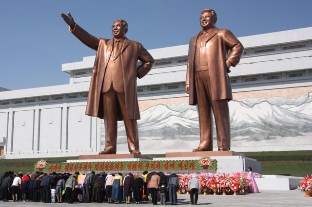 People paying homage to the statues of Kim Il-sung and Kim Jong-il, April 2012