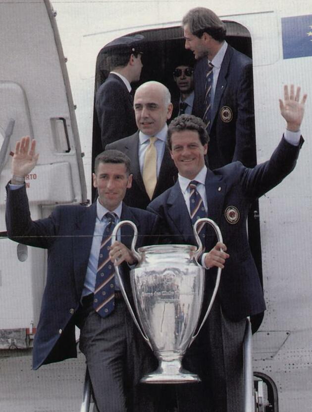 Tassotti (left) holds the UEFA Champions League trophy along with manager Fabio Capello, following Milan's victory in the 1993–94 edition of the tournament