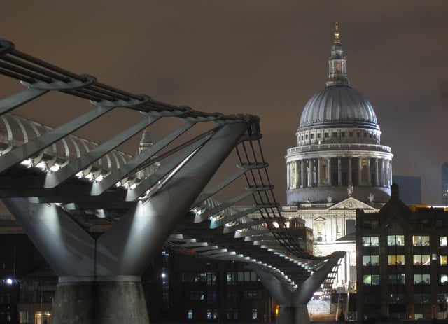 St Paul's illuminated, with the Millennium Bridge in the foreground