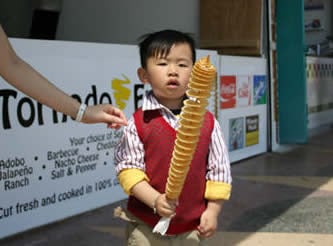A child holding tornado fries