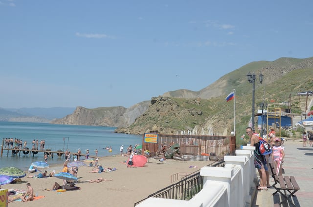 June 2015: Tourists in Crimea with Russian flag flying