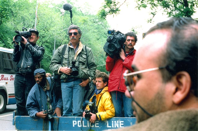 News photographers and reporters waiting behind a police line in New York City, in May 1994