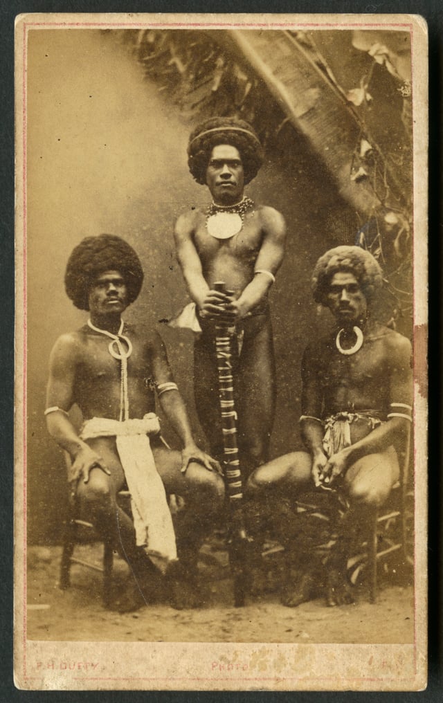 Three Kai Colo men in traditional Fijian attire