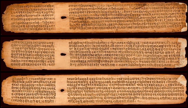 A few palm leaves from the Buddhist Sanskrit text Shisyalekha composed in 5th-century by Candragomin. Shisyalekha was written in Devanagari script by a Nepalese scribe in 1084 CE (above). The manuscript is in the Cambridge University library..