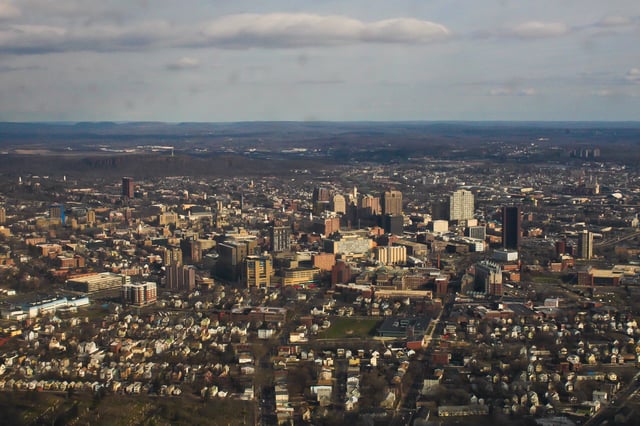 The city from the south with The Hill in the foreground.  East Rock is visible in the background.