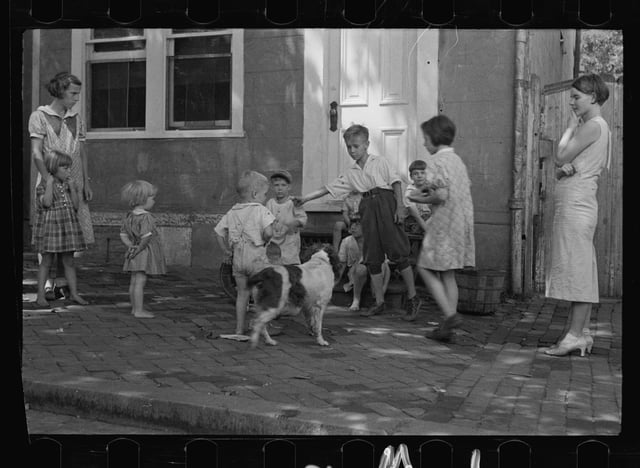 Poor children playing on sidewalk in Georgetown during the Great Depression, Carl Mydans, 1935