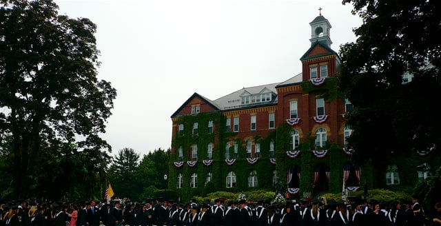 Graduates process onto the quad in front of Alumni Hall.