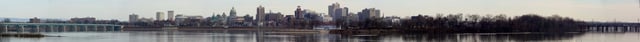 A panoramic of downtown Harrisburg from Wormleysburg, Pennsylvania, across the Susquehanna River from downtown. The view extends from the M. Harvey Taylor Memorial Bridge on the far left, across the cityscape including the Pennsylvania State Capitol and City Island, to the Walnut Street Bridge and the Market Street Bridge, as seen in March 2013.