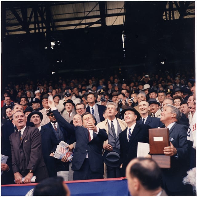 Opening Day of 1961 baseball season. President Kennedy throws out the first ball at Griffith Stadium, the home field of the Washington Senators, as LBJ and Hubert Humphrey look on.