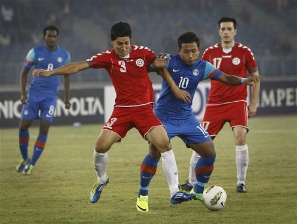 The Afghanistan national football team (in red uniforms) before its first win over India (in blue) during the 2011 SAFF Championship.