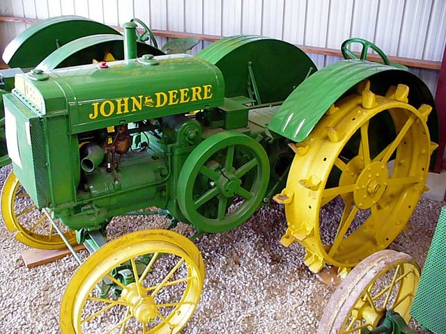 A 1920s John Deere tractor with the spoked flywheel on the engine. The large moment of inertia of the flywheel smooths the operation of the tractor