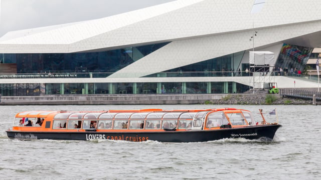 Boats give tours of the city, such as this one in front of the EYE Film Institute Netherlands.