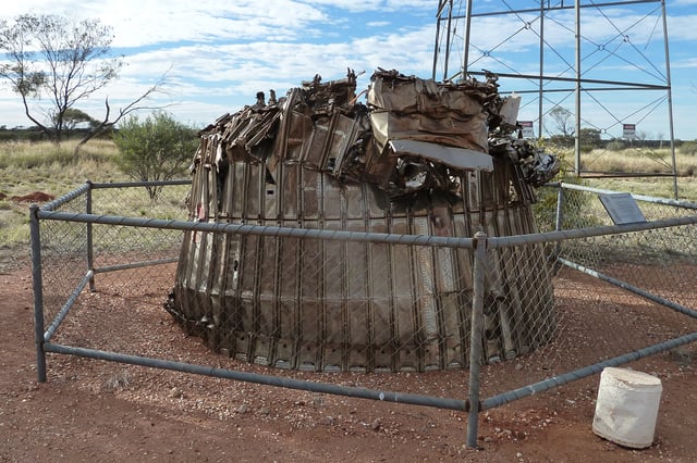 The placard reads: "Remains of the first Blue Streak rocket launched from Woomera 5 June 1964. Discovered 50km SE of Giles in 1980."