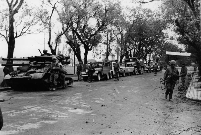 An M50 Ontos leads evacuation convoy of commandeered vehicles, 31 January