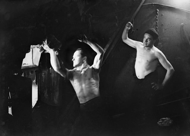 Stokers in the boiler room on board HMT Stella Pegasi, Scapa Flow, 6 June 1943