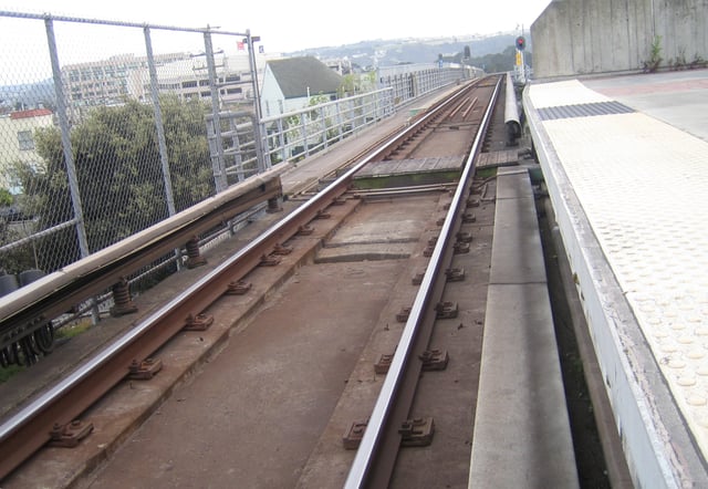 Location of the third rail changes at the station. On the left side of the track in the distance is the emergency walkway — the third rail is across the track from this walkway.