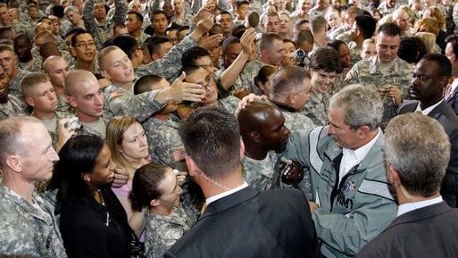 Secret Service agents guard President George W. Bush in 2008.