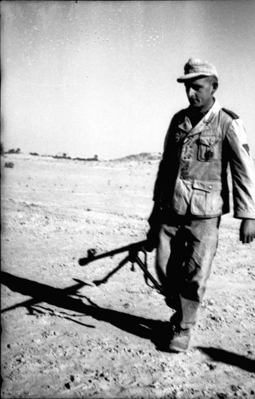 Division infantryman carrying anti-tank rifle in north African desert