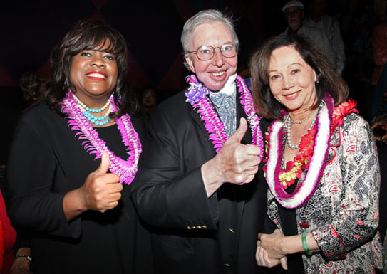 Ebert and his wife Chaz Hammelsmith Ebert (left) giving the thumbs up to Nancy Kwan (right) at the Hawaii International Film Festival on October 20, 2010