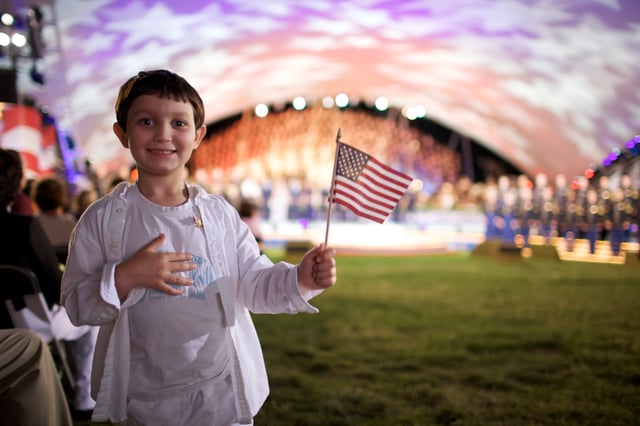 A boy holds an American flag during the 2009 National Memorial Day Concert in Washington, D.C.