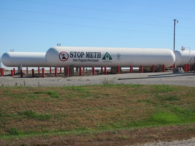 Anti-meth sign on tank of anhydrous ammonia, Otley, Iowa. Anhydrous ammonia is a common farm fertilizer that is also a critical ingredient in making methamphetamine. In 2005, Iowa used grant money to give out thousands of locks to prevent criminals from getting into the tanks.