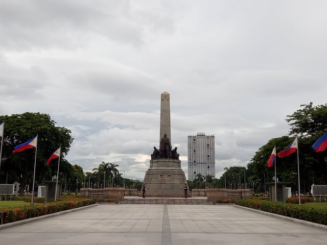 View of the Rizal Monument in Rizal Park with the controversial Torre de Manila looming in the background.