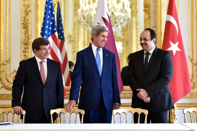 Davutoğlu (left) with US Secretary of State John Kerry (centre) and Qatari Foreign Minister Khalid al-Attiyah (right) discussing Israel-Hamas ceasefire deal (Paris, 2014)
