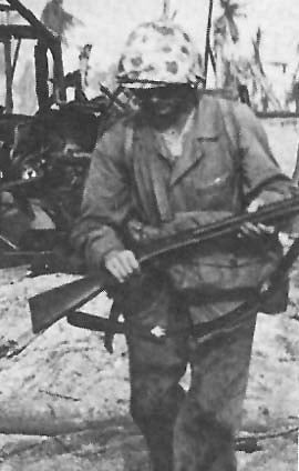 A United States Marine carrying a Winchester M97 shotgun during World War II