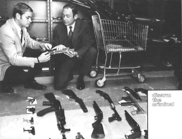 ATF investigators display weapons seized for violations of the Gun Control Act