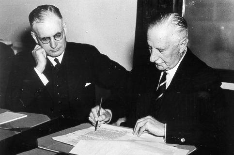 Governor General of Australia The Lord Gowrie (right) signing the declaration of war against Japan with Prime Minister John Curtin (left) looking on. (8 December 1941)