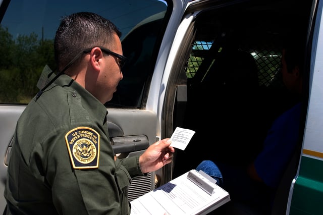 Border Patrol Agent reading the Miranda Rights to a suspect.