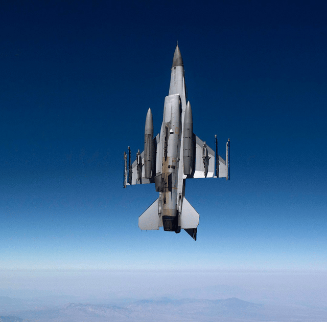 View of underside of F-16 during a vertical climb