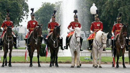 The Honor Guards from the Guides Cavalry Regiment, in traditional Red Coat, welcoming the U.S. President George W. Bush at the Presidency in Islamabad in 2006.