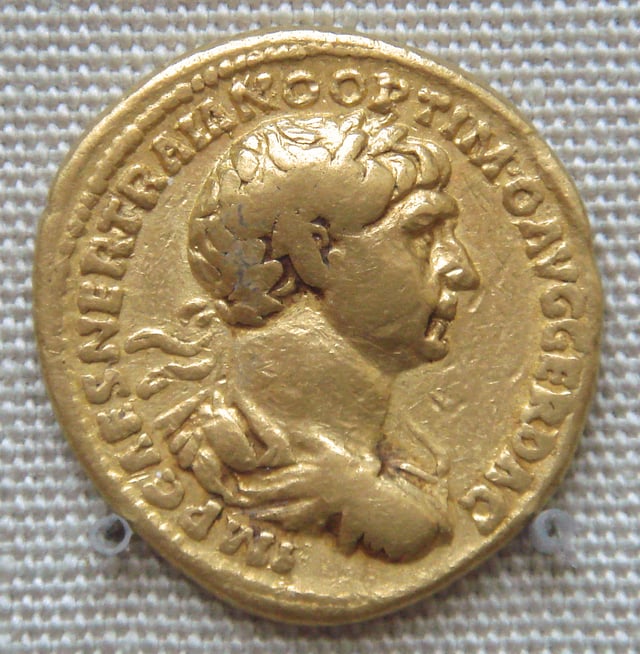 A coin of Trajan, found together with coins of the Kushan ruler Kanishka, at the Ahin Posh Buddhist Monastery, Afghanistan. Caption: IMP. CAES. NER. TRAIANO OPTIMO AVG. GER. DAC.